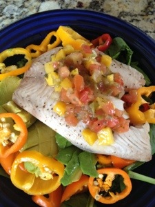 Mexican style tilapia over spinach, avocado, roasted peppers, topped with mango salsa